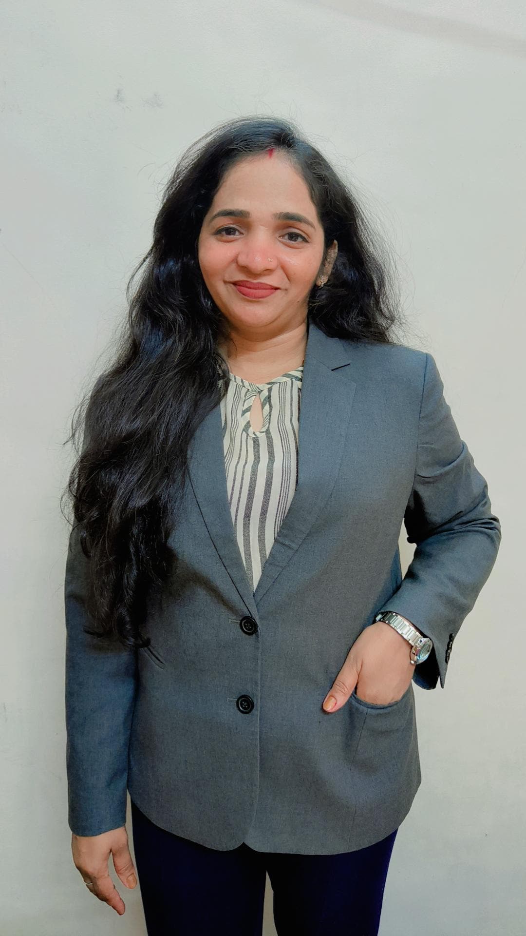 Lalita Shukla standing confidently in a grey blazer